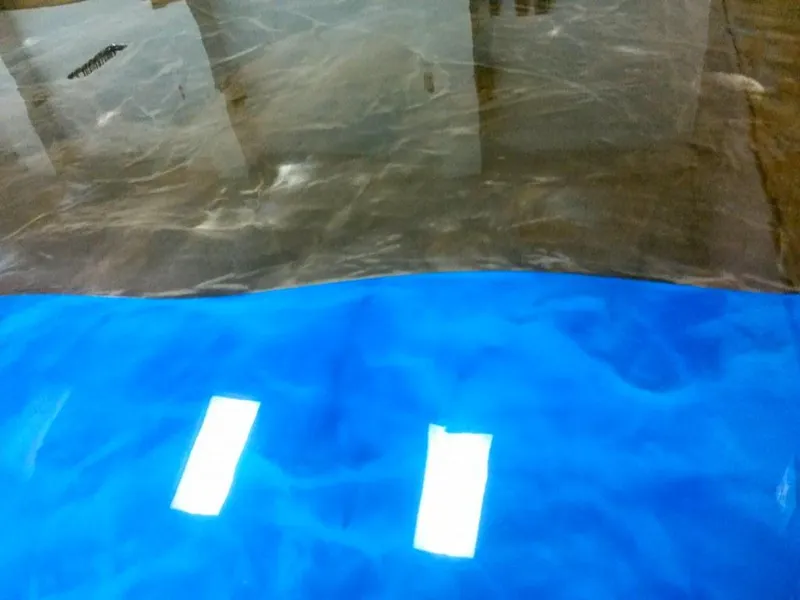 Blue metallic epoxy floor reflecting overhead lights