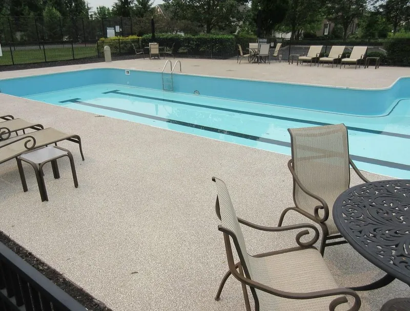 Light flake coating on a pool deck with patio furniture